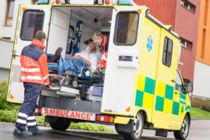 Person getting loaded into an ambulance, when should you hire a workman's comp attorney